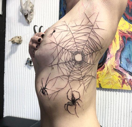 Photo of spider web tattoo on body.