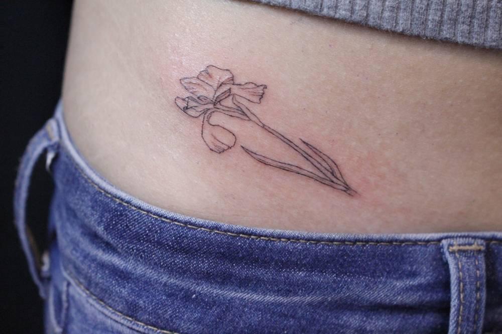 Kis írisz tetoválás a lány testén