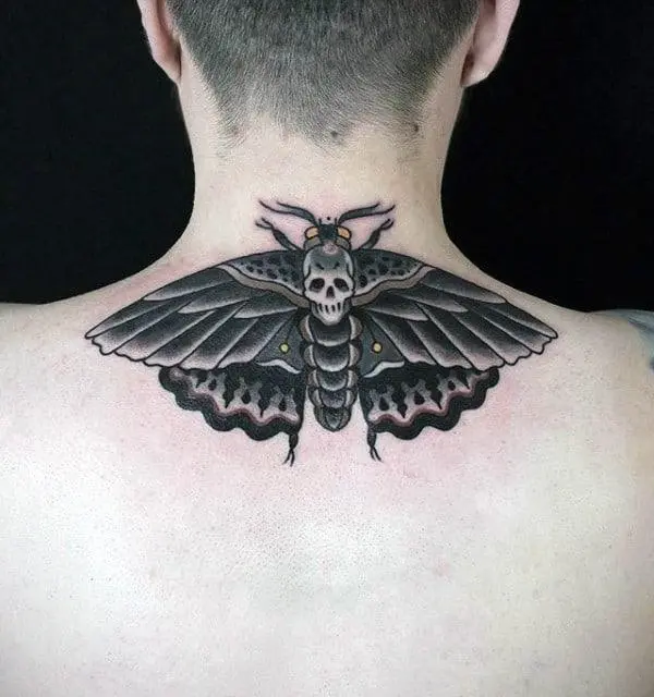 Tattoo of a moth on a man's neck