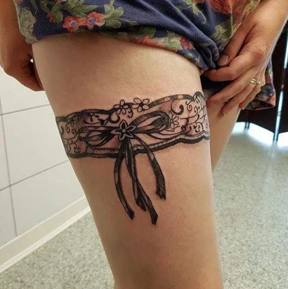 Garter tattoo on female leg