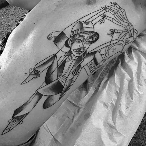 Puppeteer tattoo on the side of a guy