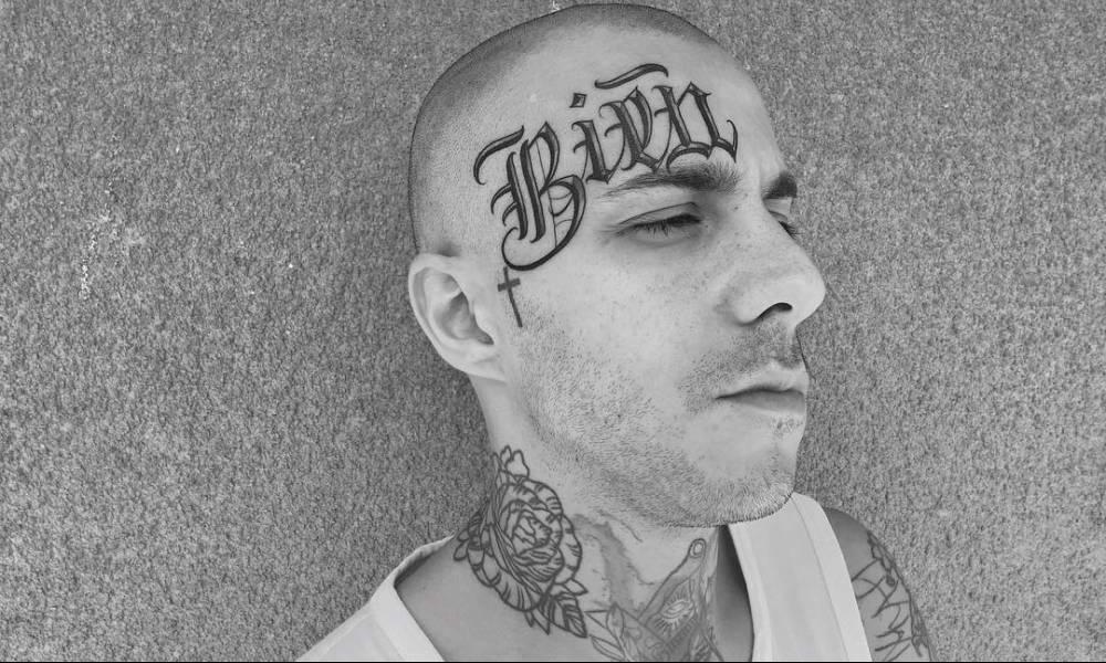 Tattoo inscription on the forehead of a man