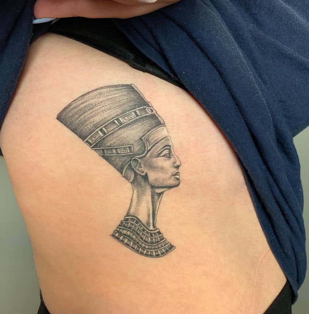 Photo of Nefertiti tattoo on the body.