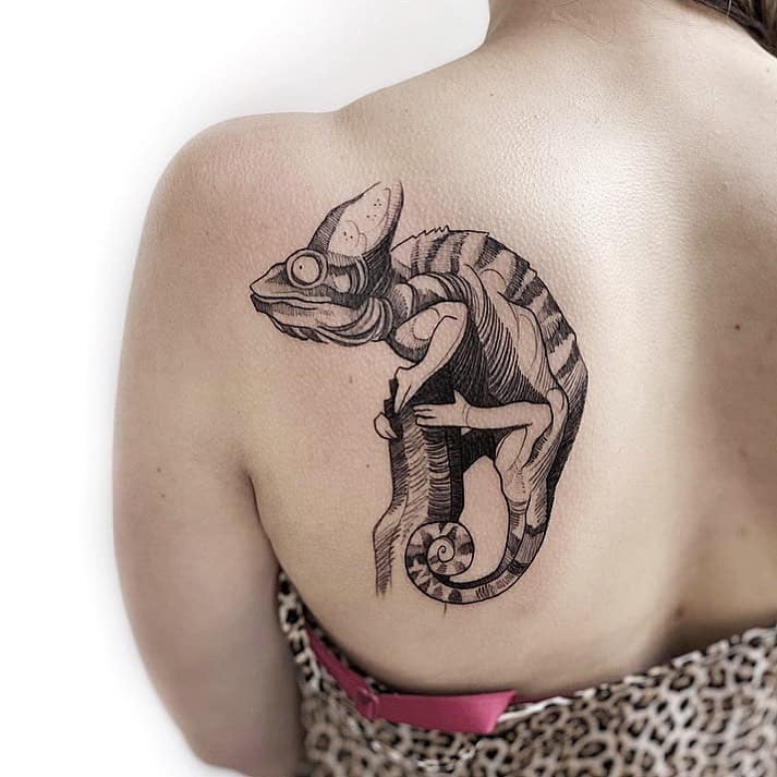 Photo of chameleon tattoo on body.