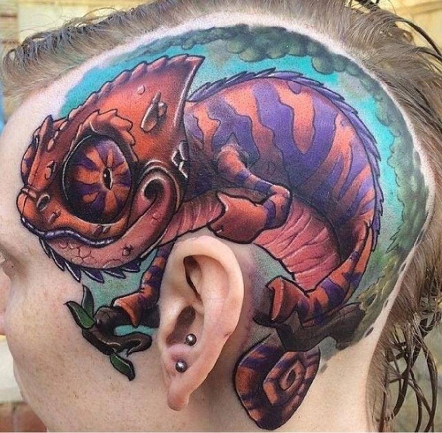 Photo of chameleon tattoo on head.