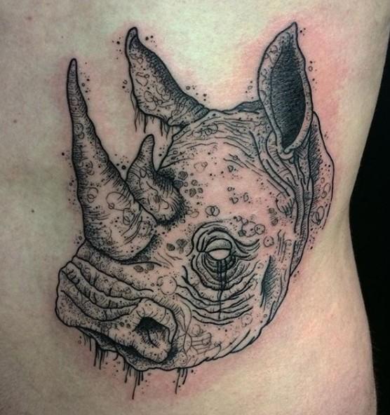Photo of a rhinoceros tattoo on the body.
