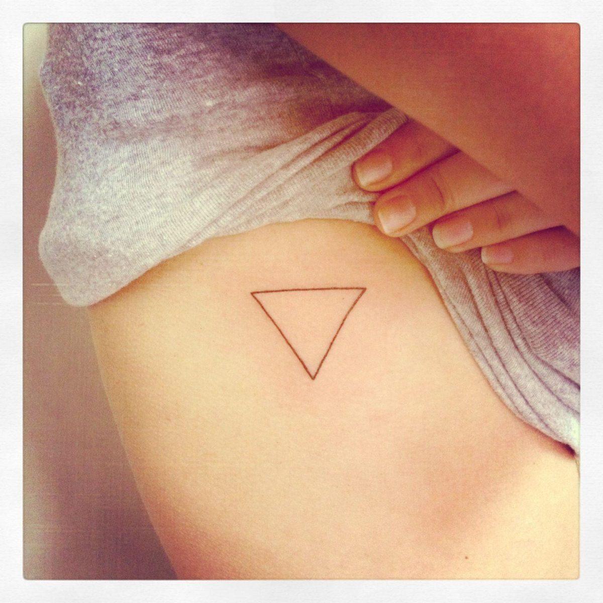 Photo of inverted triangle tattoo on body.