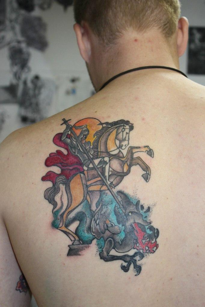 Photo of the tattoo of St. George the Victorious on the body.