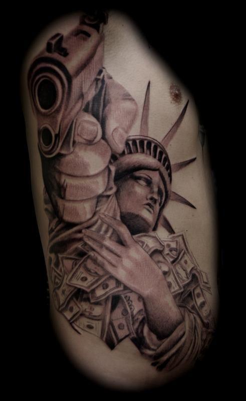 Photo of statue of liberty tattoo on body.
