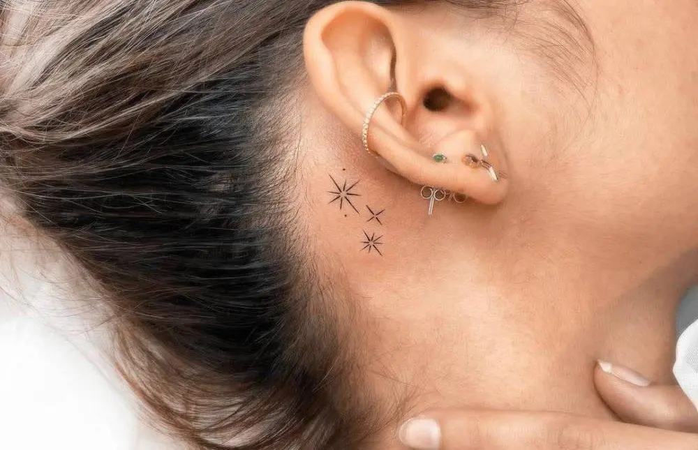 Star tattoo behind the girl's ear