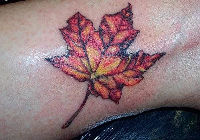 Photo of a maple tattoo on the leg.