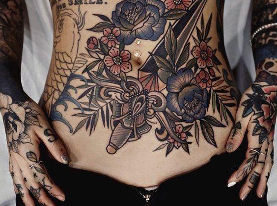 Large tattoo on the waist of the girl