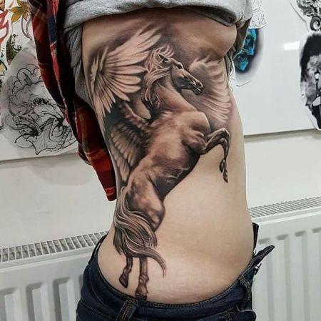 Photo of pegasus tattoo on body.