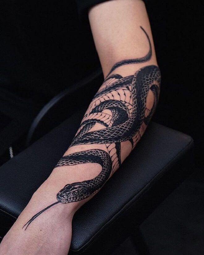 Photo of a snake tattoo on the arm.