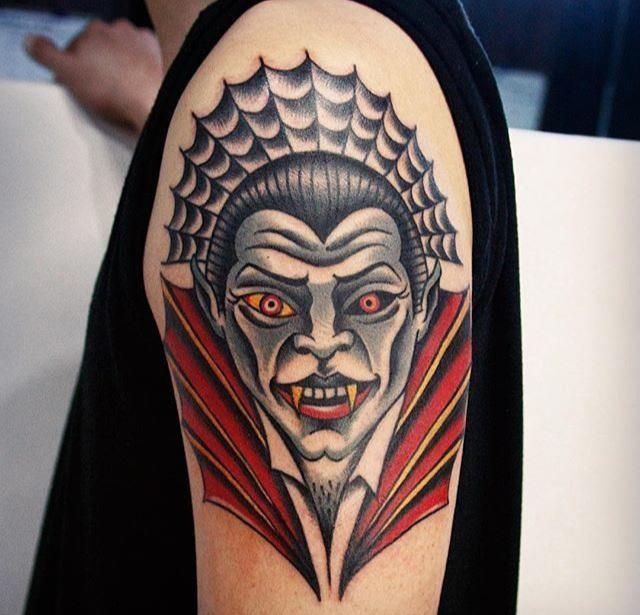 Photo of a tattoo with vampires on the arm.
