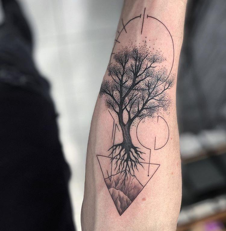Photo of a tree tattoo on the arm.